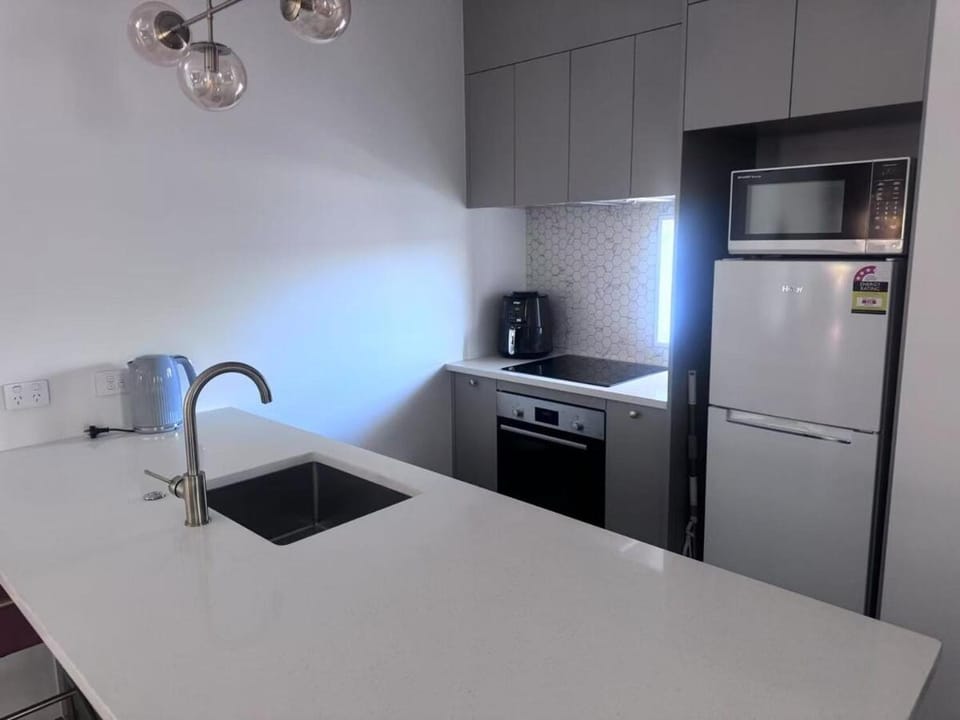 Kitchen or kitchenette, dishwasher, oven, stove