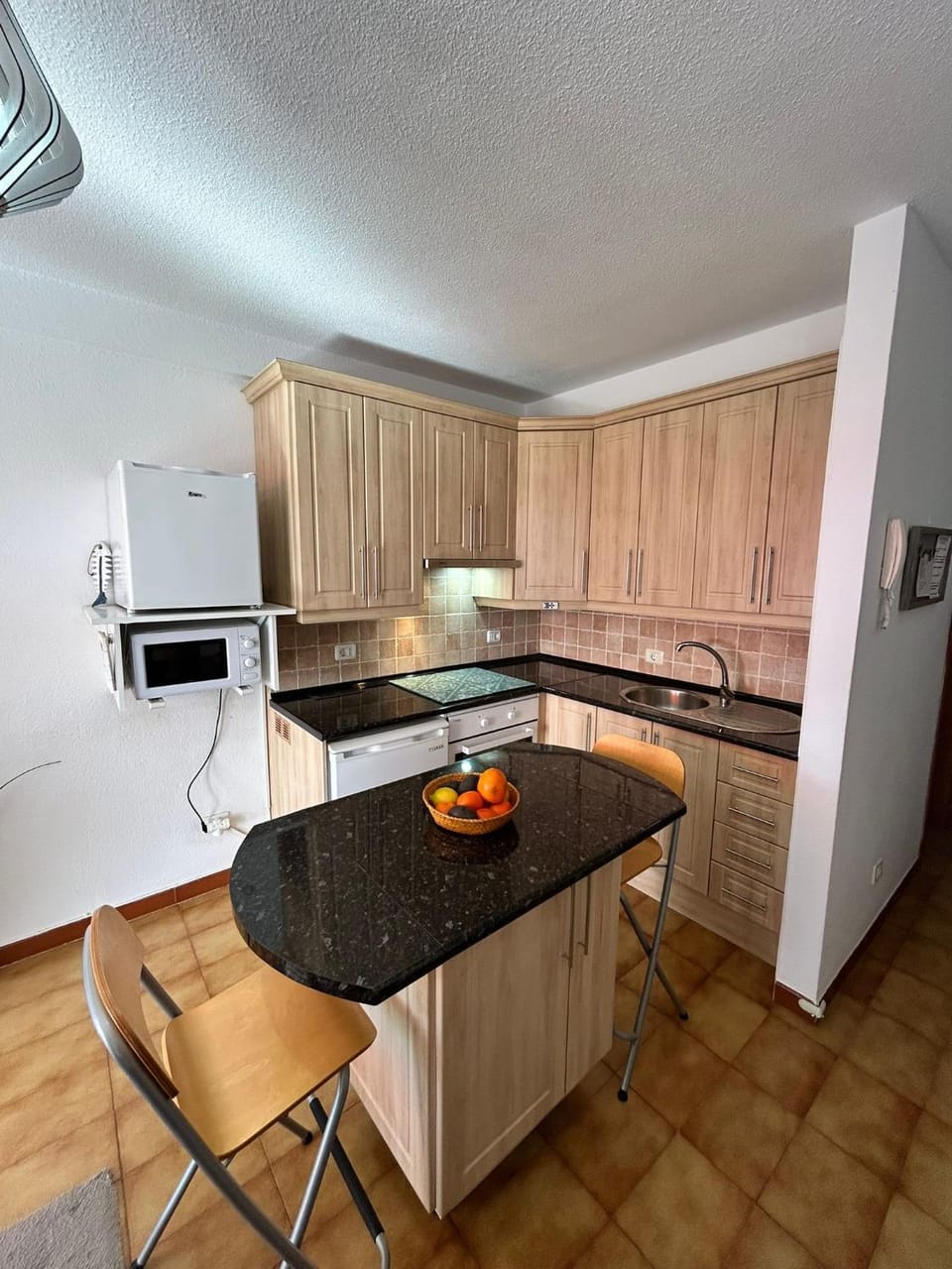 Kitchen or kitchenette, microwave, oven, stove
