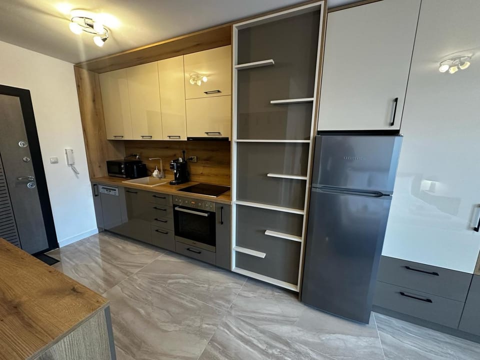 Kitchen or kitchenette, dishwasher, oven, stove