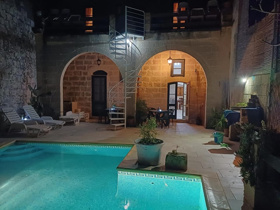 Property building, Patio, Night, Natural landscape, Pool view, Swimming pool, sunbed