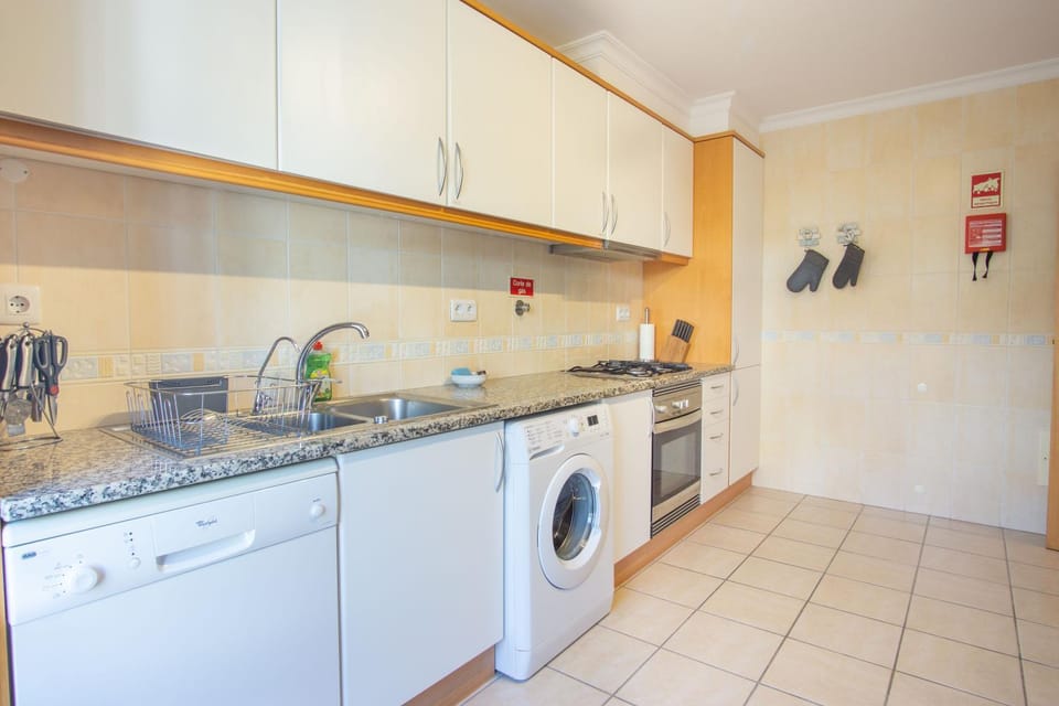 Kitchen or kitchenette, dishwasher, stove, washing machine