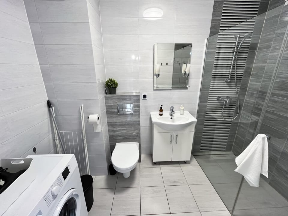 Shower, Toilet, Bathroom, towels, washing machine, dryer
