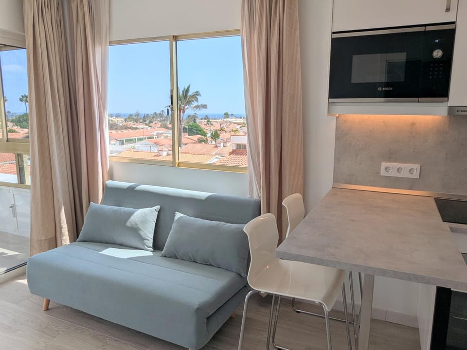 View (from property/room), Living room, Seating area, Dining area, Sea view