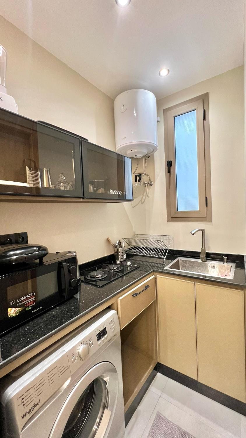 Kitchen or kitchenette, stove, washing machine