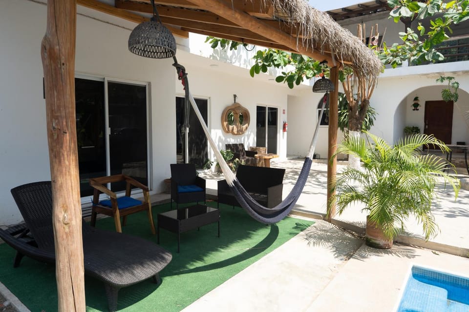 Property building, Patio, Day, Garden, Living room, Seating area, Garden view, Pool view, Swimming pool, sunbed
