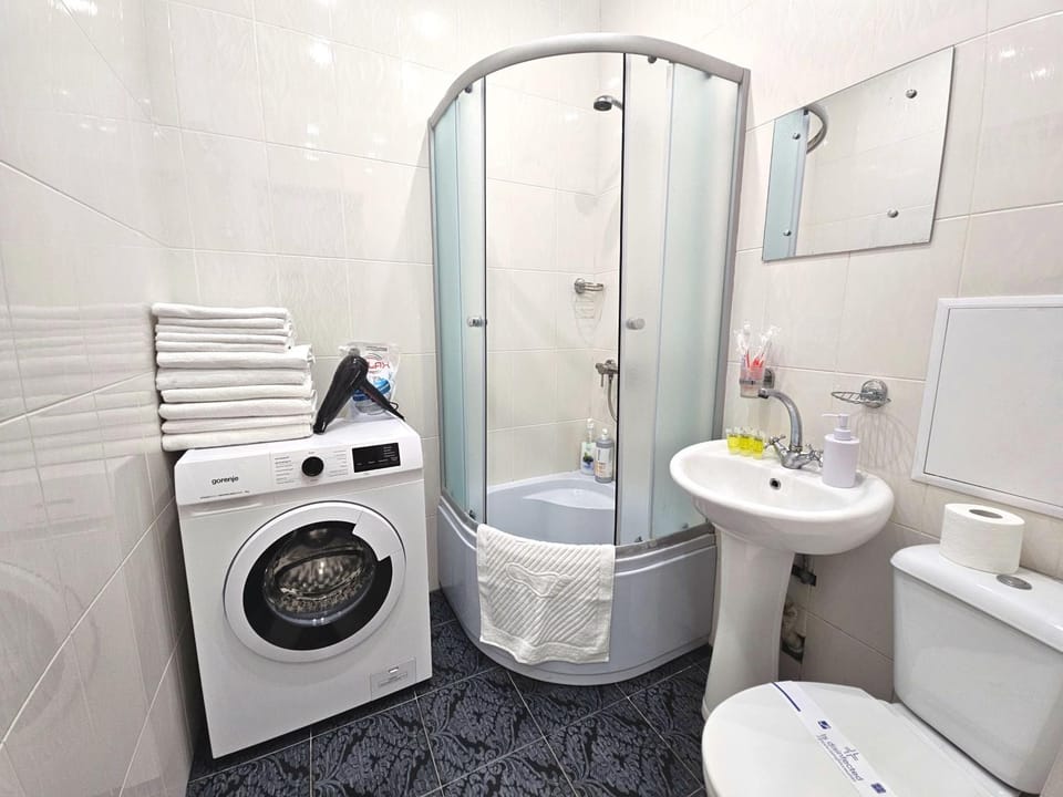 Shower, Toilet, Bathroom, towels, washing machine, dryer
