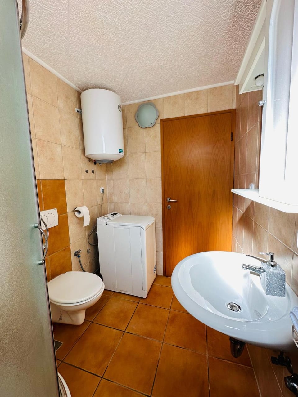 Shower, Toilet, Bathroom, hair dryier, towels, washing machine