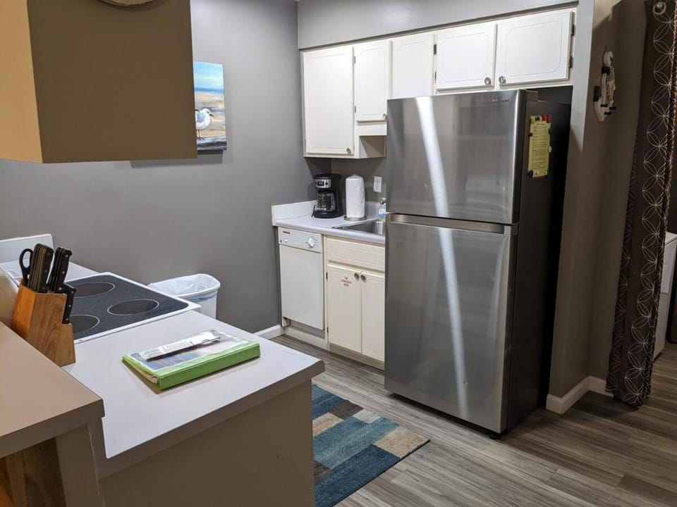 Kitchen or kitchenette, dishwasher, oven, stove