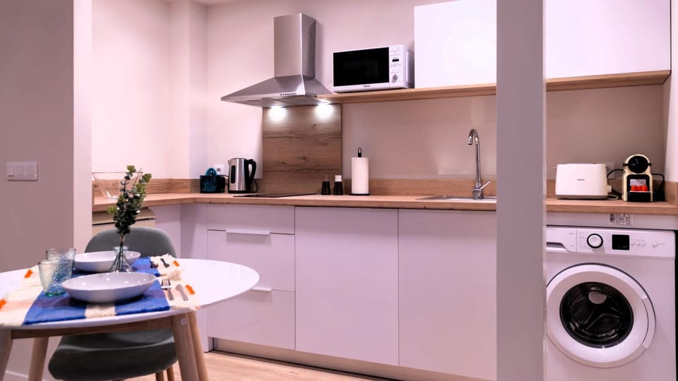 Kitchen or kitchenette, stove, toaster, washing machine