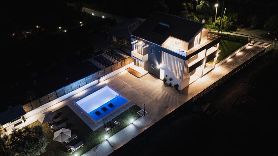 Property building, Patio, Night, Pool view, Swimming pool, sunbed