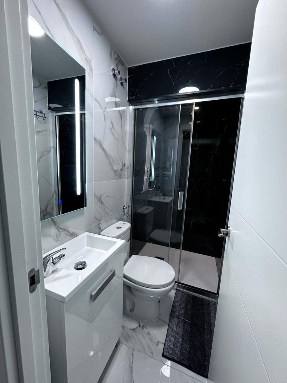 Shower, Toilet, hair dryier, towels, laundry