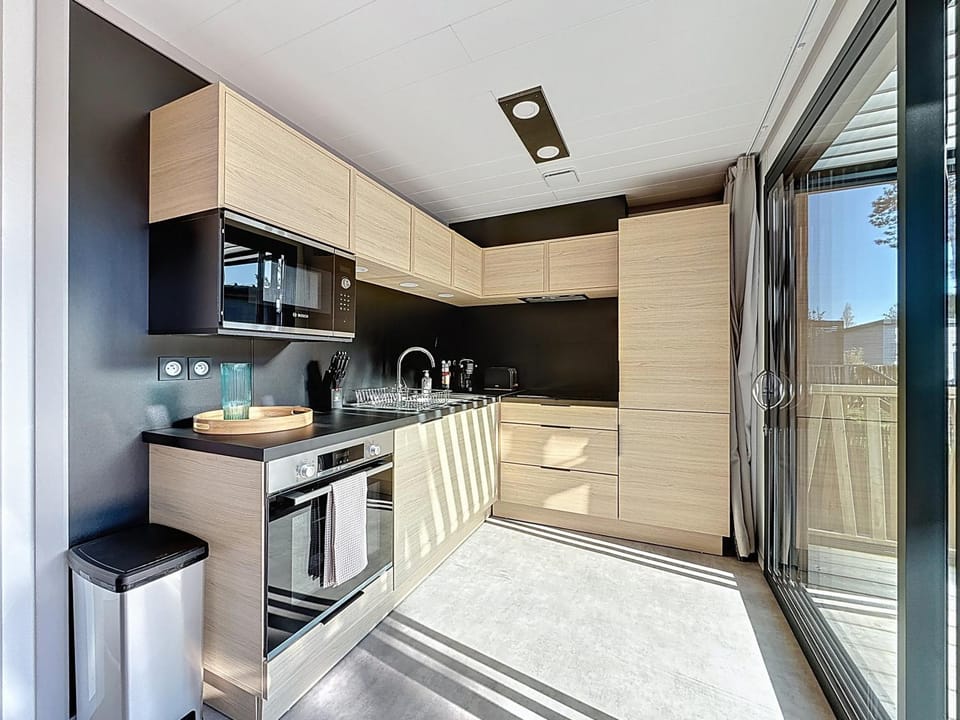 Kitchen or kitchenette, dishwasher, oven, stove