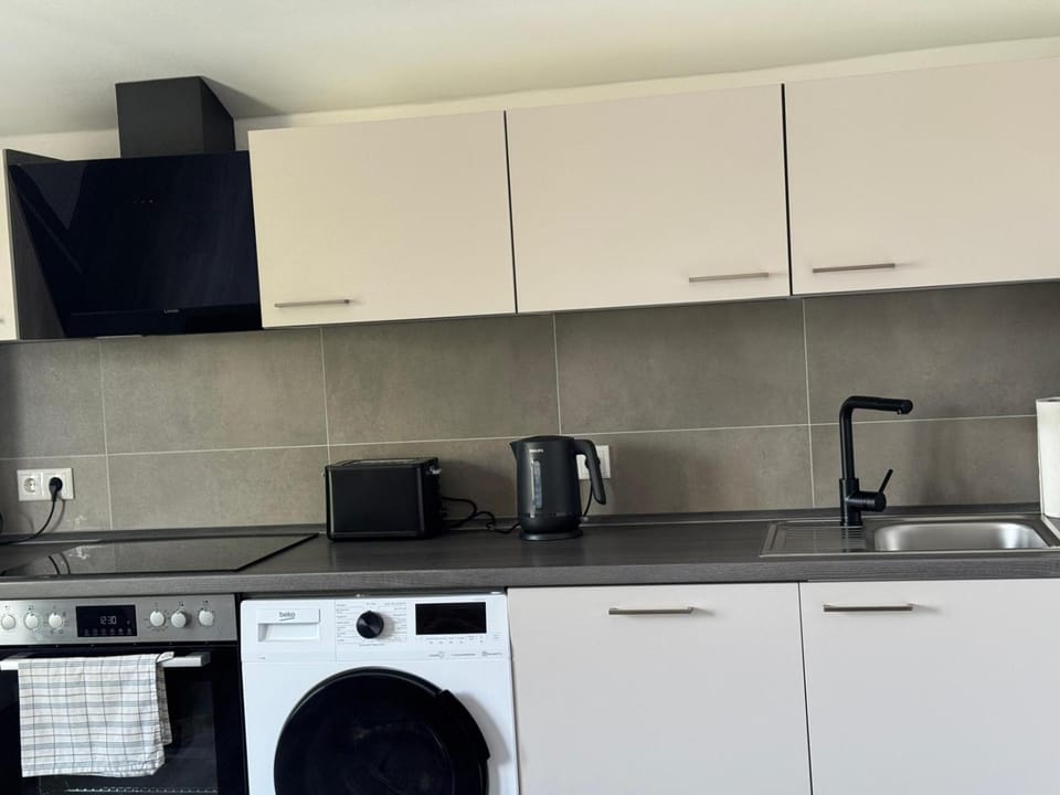 Kitchen or kitchenette, dishwasher, stove, toaster, washing machine