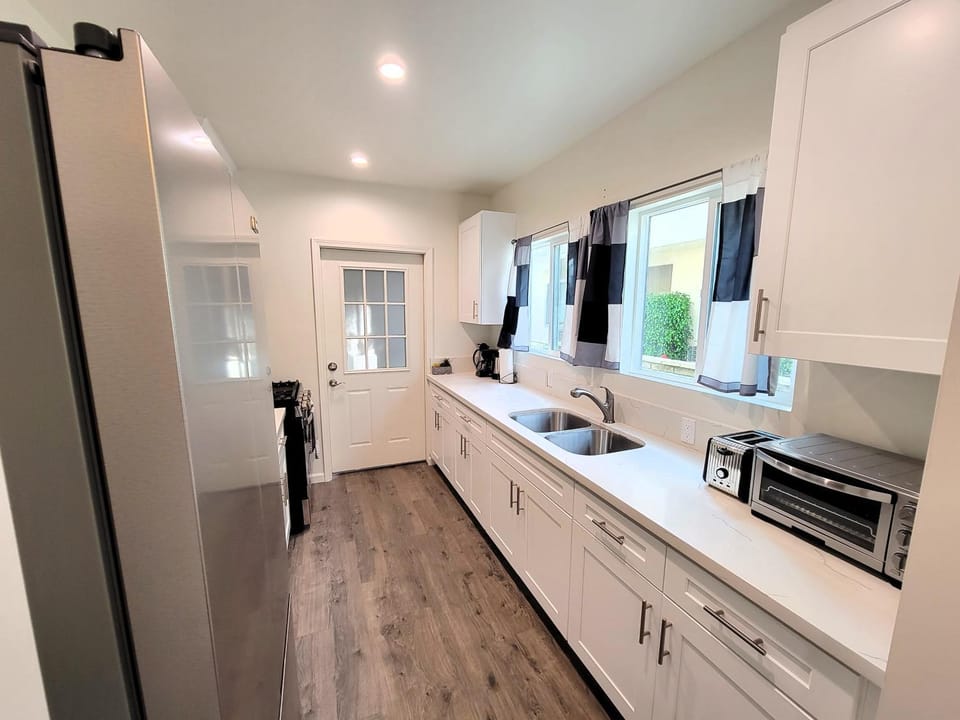 Kitchen or kitchenette, dishwasher, oven, stove