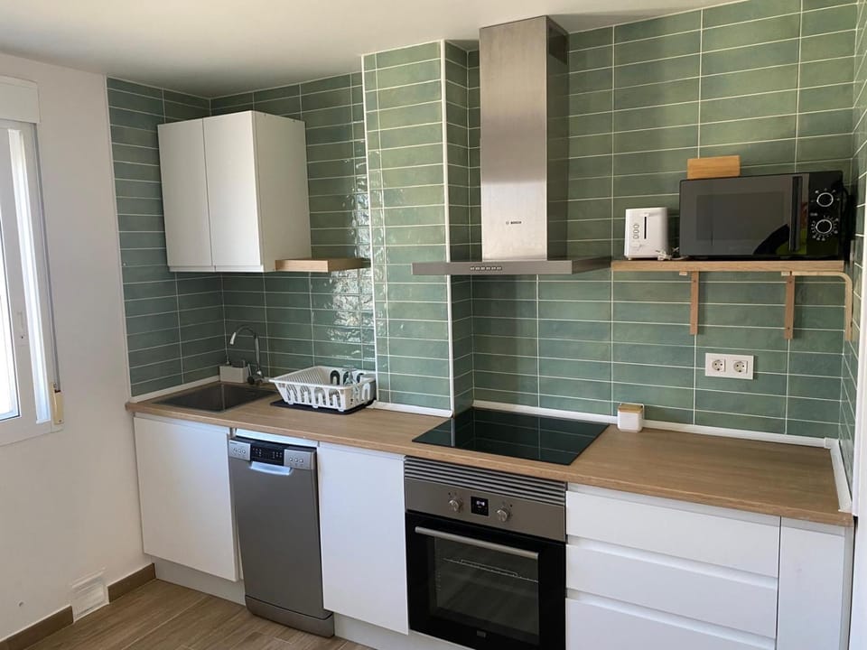Kitchen or kitchenette, dishwasher, oven, stove, toaster