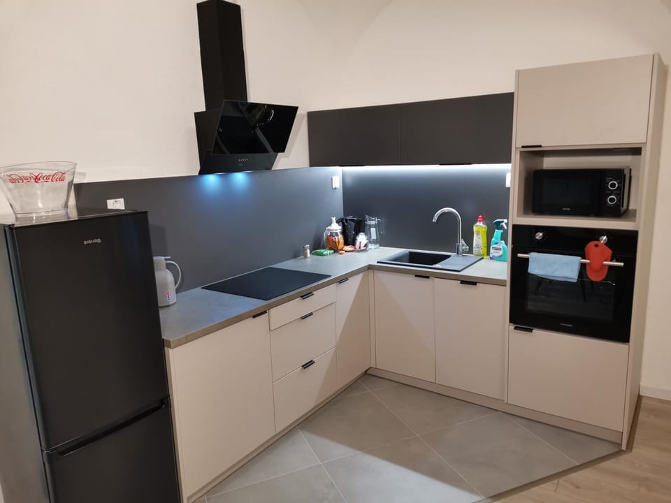 Kitchen or kitchenette, dishwasher, oven, stove