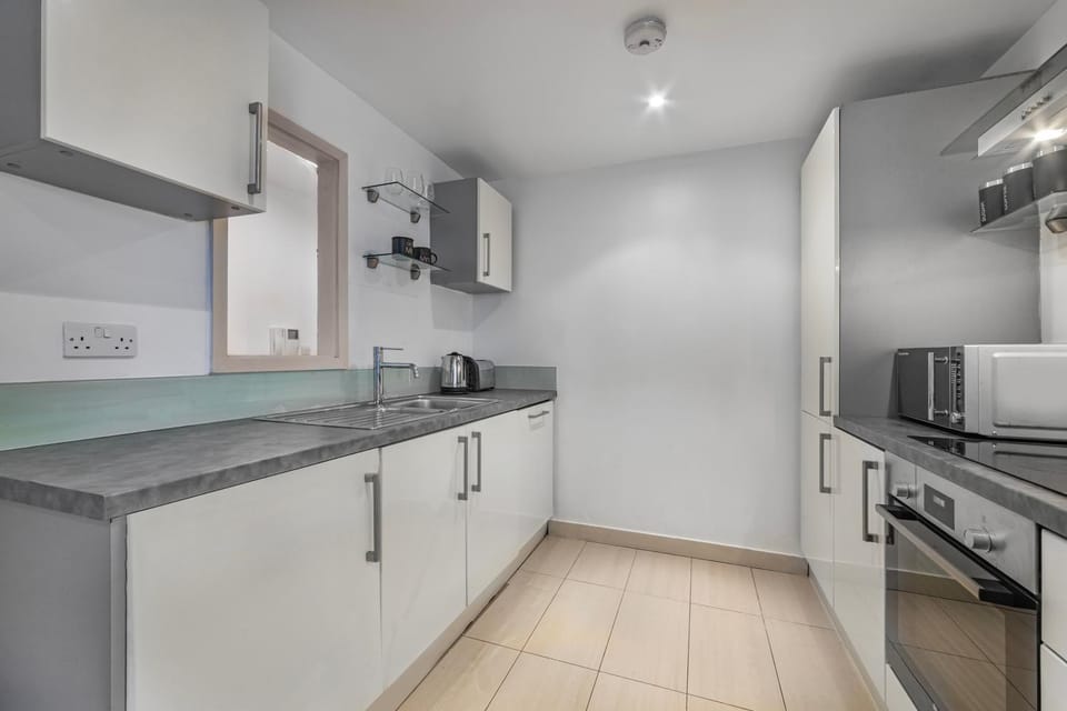 Kitchen or kitchenette, dishwasher, oven, stove, toaster