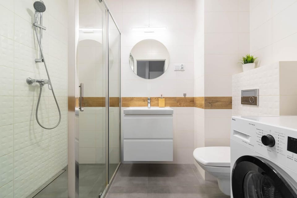 Shower, Toilet, Bathroom, hair dryier, towels, washing machine