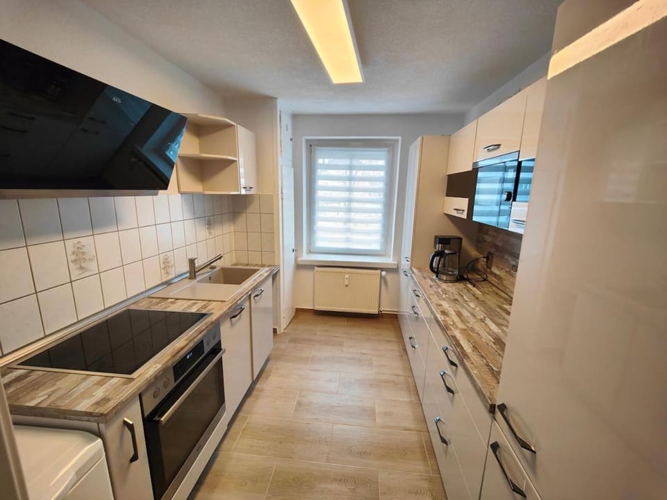 Kitchen or kitchenette, dishwasher, oven, stove, washing machine