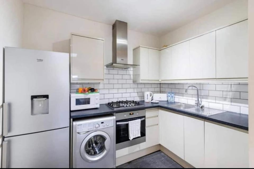 Kitchen or kitchenette, dishwasher, oven, stove, toaster, washing machine