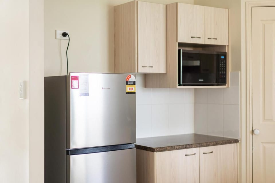 Kitchen or kitchenette, dishwasher, microwave, oven, stove