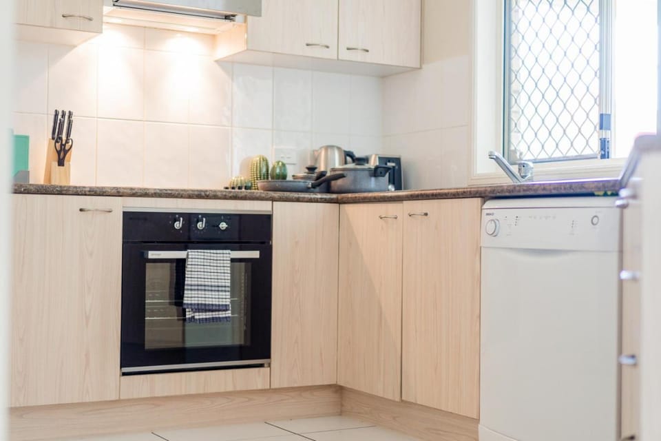 Kitchen or kitchenette, dishwasher, oven, stove