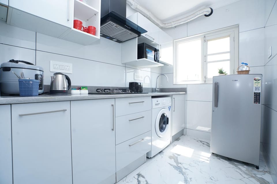 Kitchen or kitchenette, stove, toaster, washing machine
