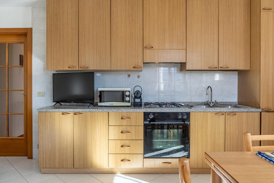 Kitchen or kitchenette, dishwasher, oven, stove