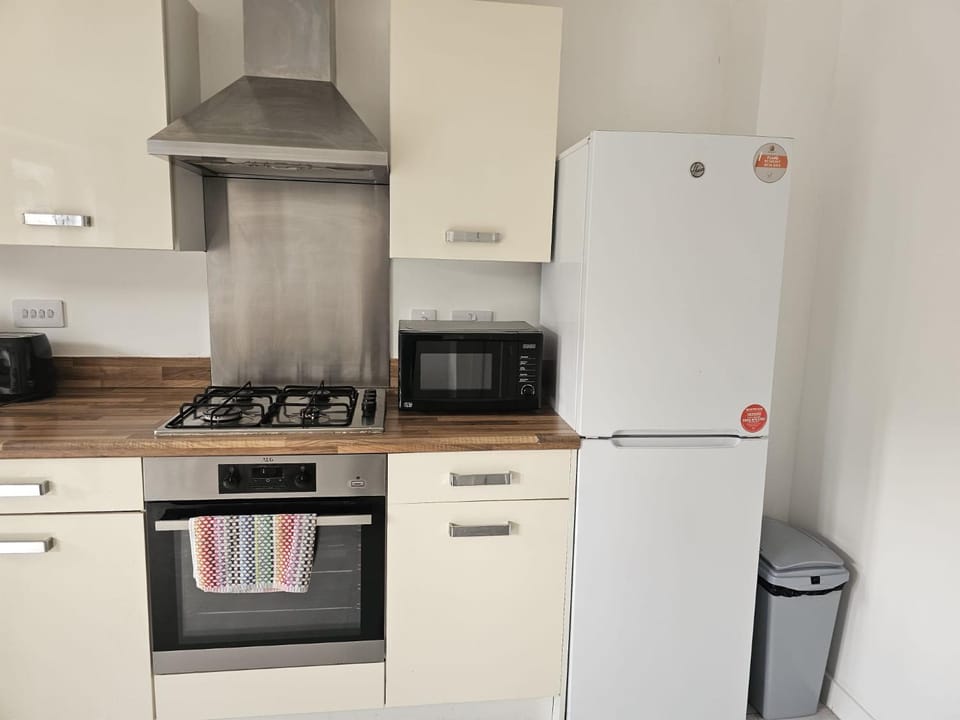 Kitchen or kitchenette, dishwasher, oven, stove, toaster