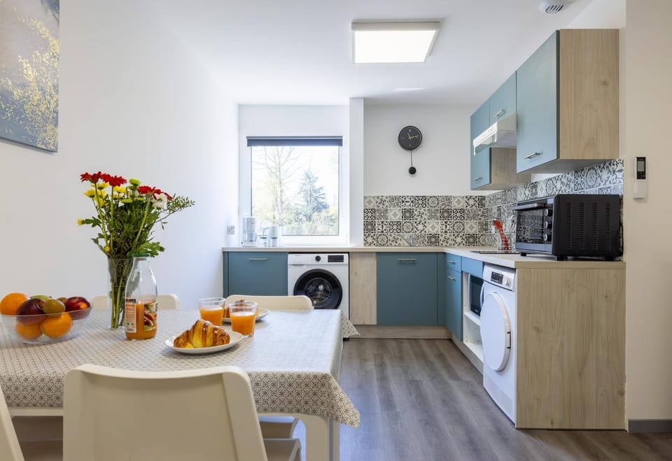 Dining area, microwave, oven, stove, toaster, washing machine, dryer, kitchen