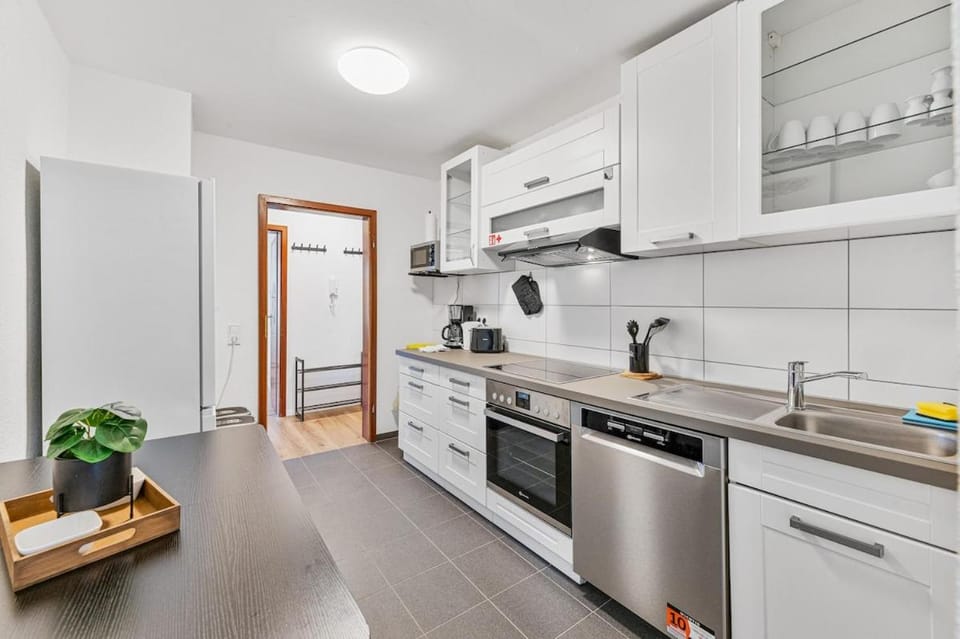 Kitchen or kitchenette, dishwasher, oven, stove