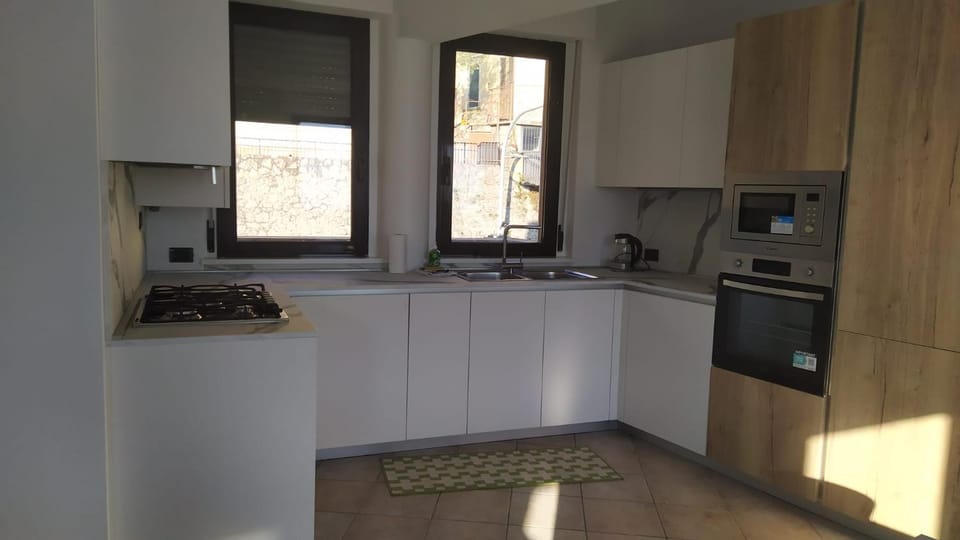 Kitchen or kitchenette, dishwasher, microwave, oven, stove