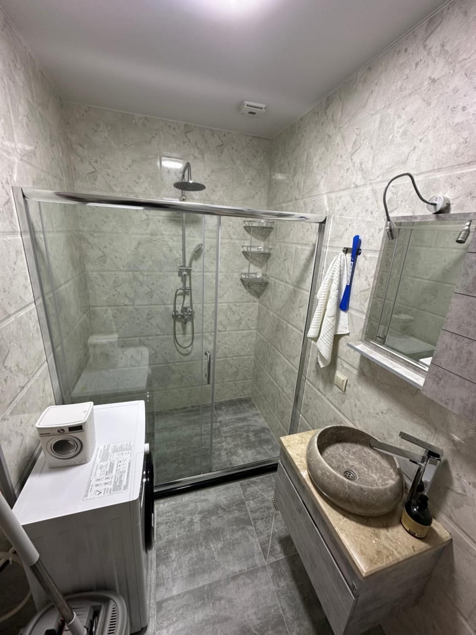 Shower, Toilet, Bathroom, hair dryier, towels, washing machine