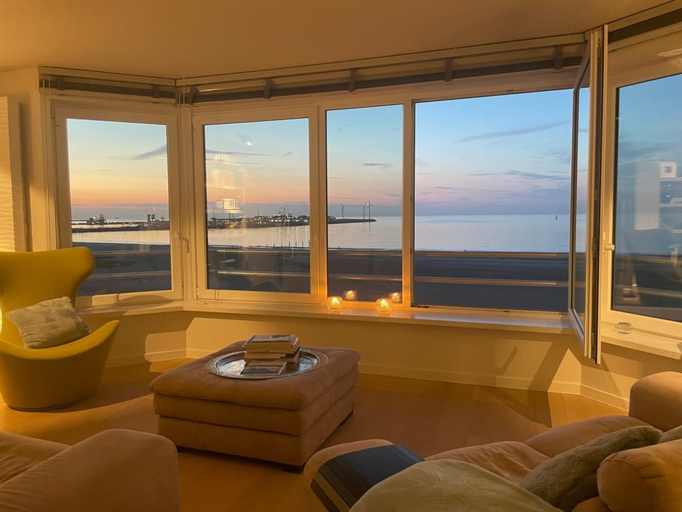 Natural landscape, View (from property/room), Living room, Seating area, Sea view, Sunset