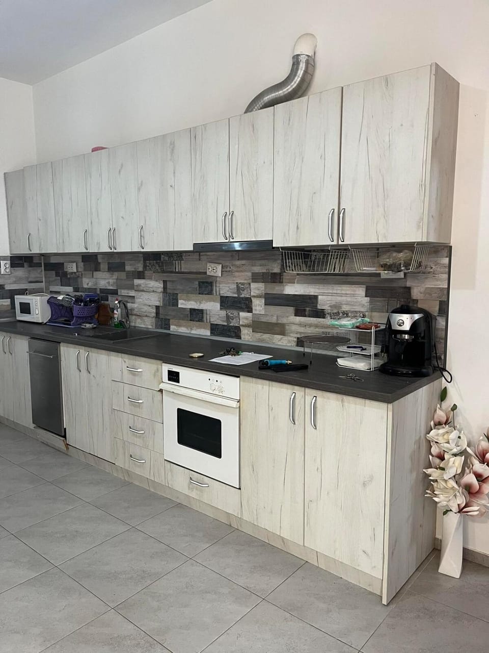 Kitchen or kitchenette, dishwasher, microwave, oven, stove