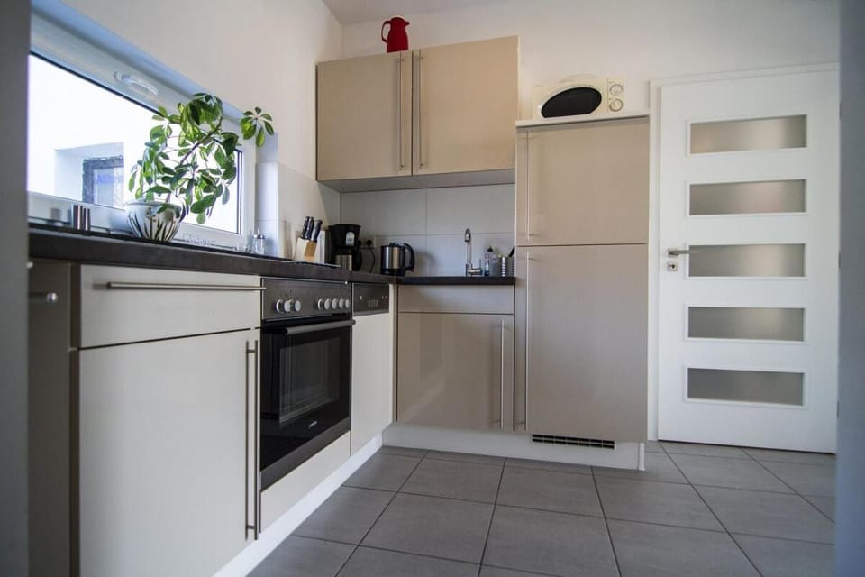 Kitchen or kitchenette, dishwasher, oven, stove
