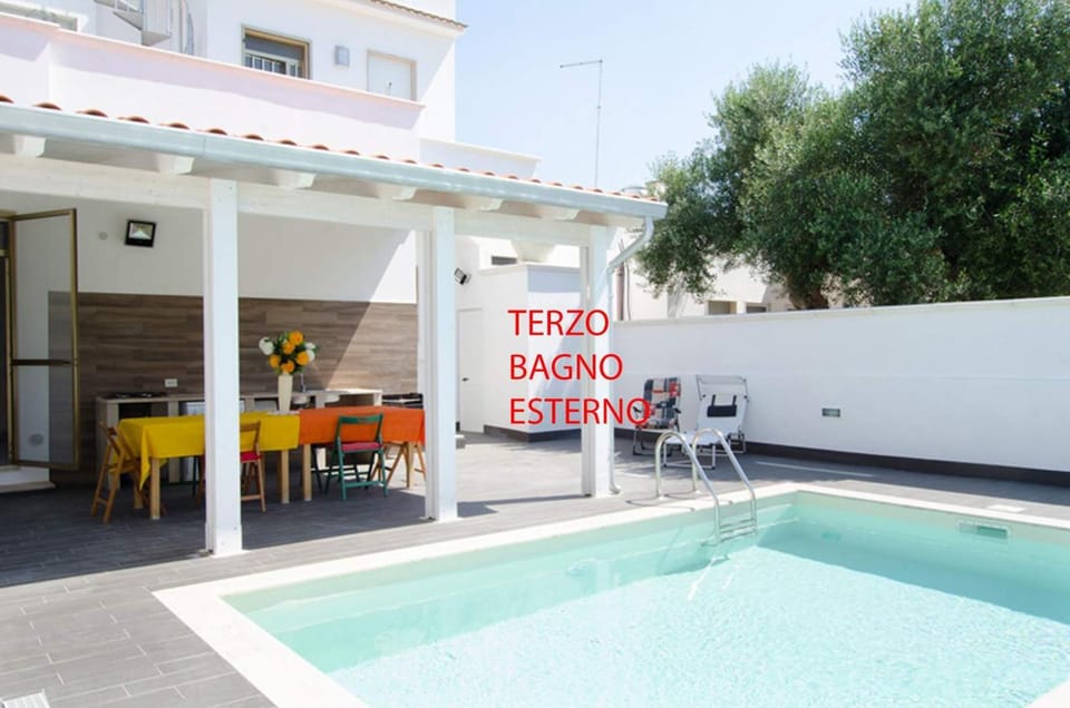 Property building, Patio, Day, Text overlay, Pool view, Swimming pool, sunbed