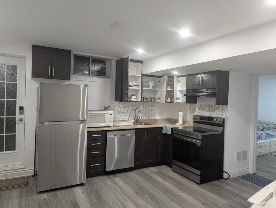 Kitchen or kitchenette, dishwasher, oven, stove
