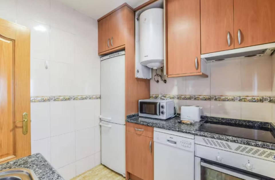 Kitchen or kitchenette, dishwasher, oven, stove