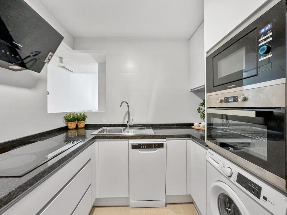 Kitchen or kitchenette, dishwasher, oven, stove, toaster, washing machine