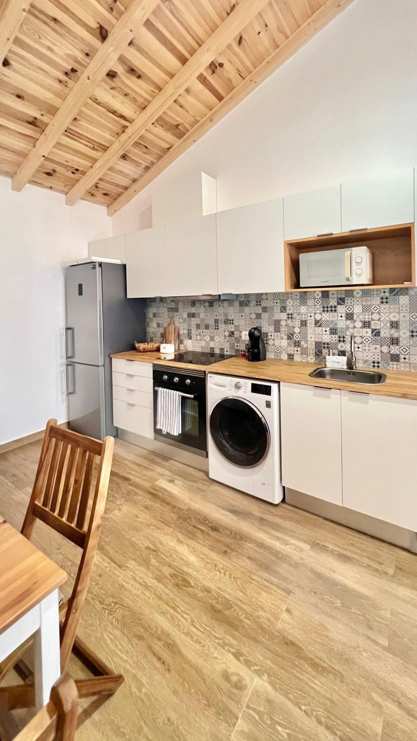 Kitchen or kitchenette, oven, stove, toaster, washing machine