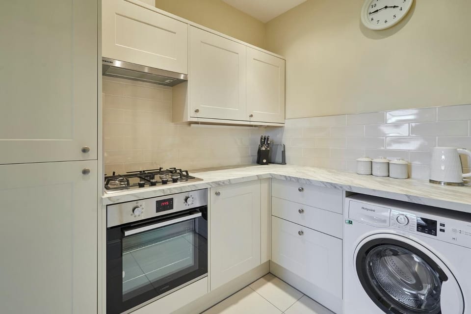 Kitchen or kitchenette, dishwasher, oven, stove, toaster, washing machine