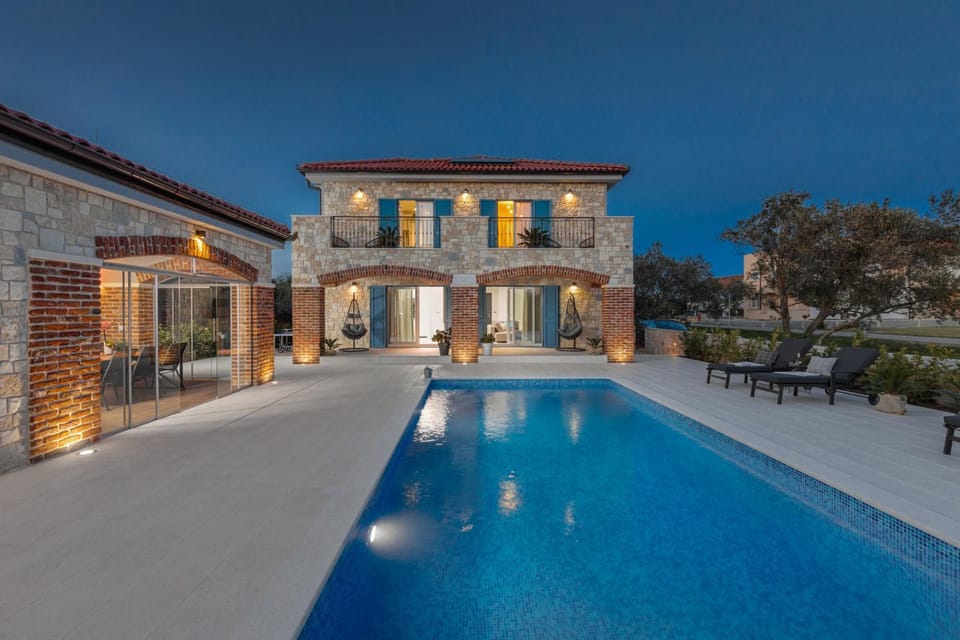 Property building, Patio, Night, Pool view, Swimming pool, Swimming pool, sunbed