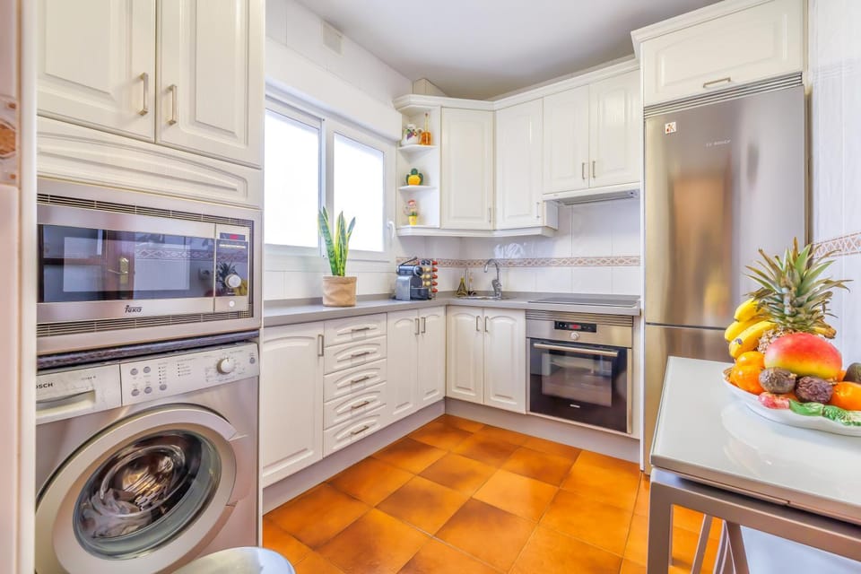 Kitchen or kitchenette, microwave, oven, stove, washing machine