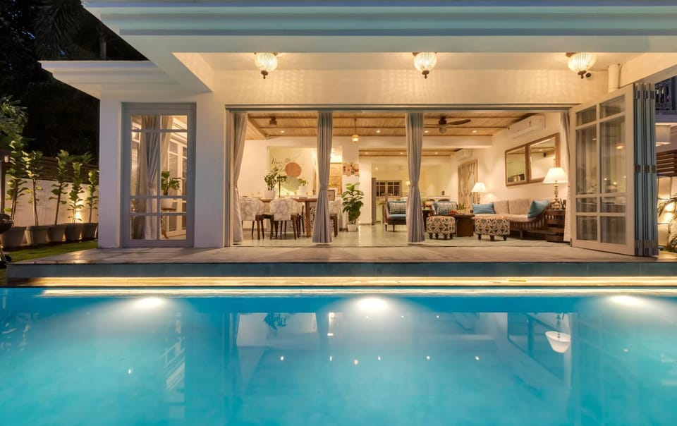 Patio, Night, Living room, Seating area, Pool view, Swimming pool