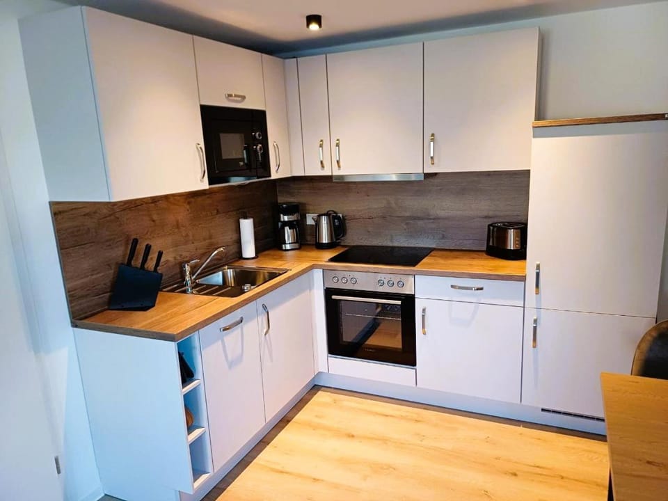 Kitchen or kitchenette, dishwasher, stove, toaster