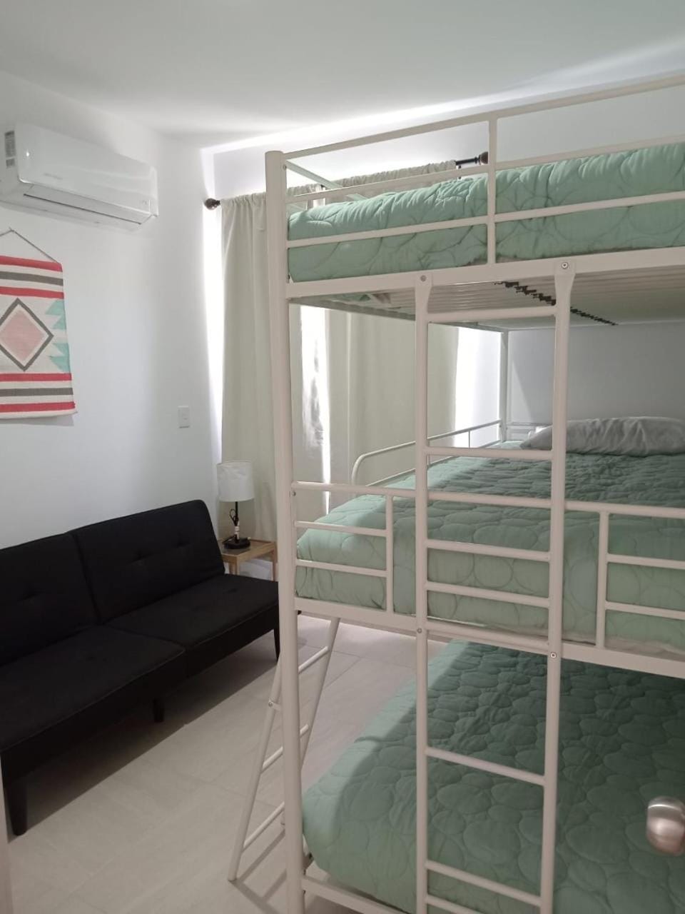 Photo of the whole room, bunk bed, air conditioner