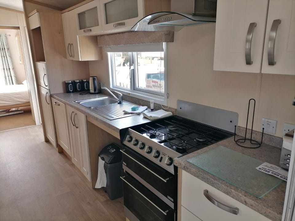 Kitchen or kitchenette, dishwasher, stove, toaster