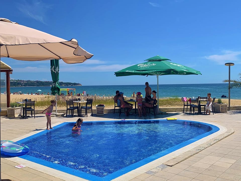 Patio, Day, Beach, Pool view, Sea view, Swimming pool, group of guests, sunbed