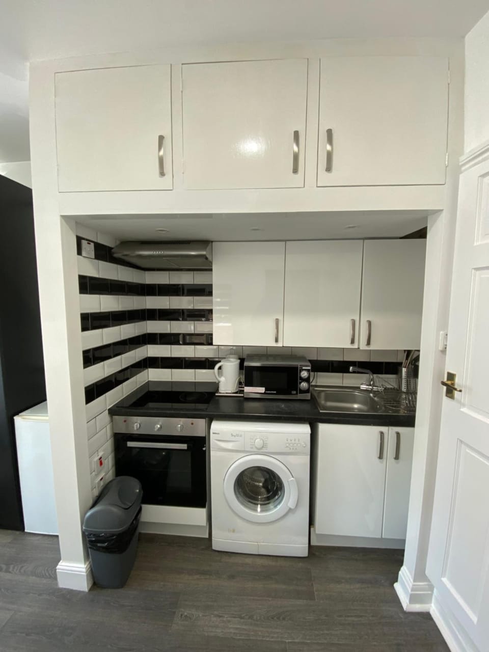 Kitchen or kitchenette, microwave, oven, stove, washing machine